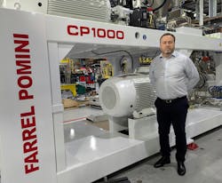 Paul Lloyd, president of Farrel Pomini, with one of his company's CP1000 continuous mixers. Paul Lloyd, president of Farrel Pomini, with one of his company's CP1000 continuous mixers.