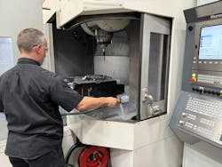 A Cavalier worker washes a new mold component. A Cavalier worker washes a new mold component.