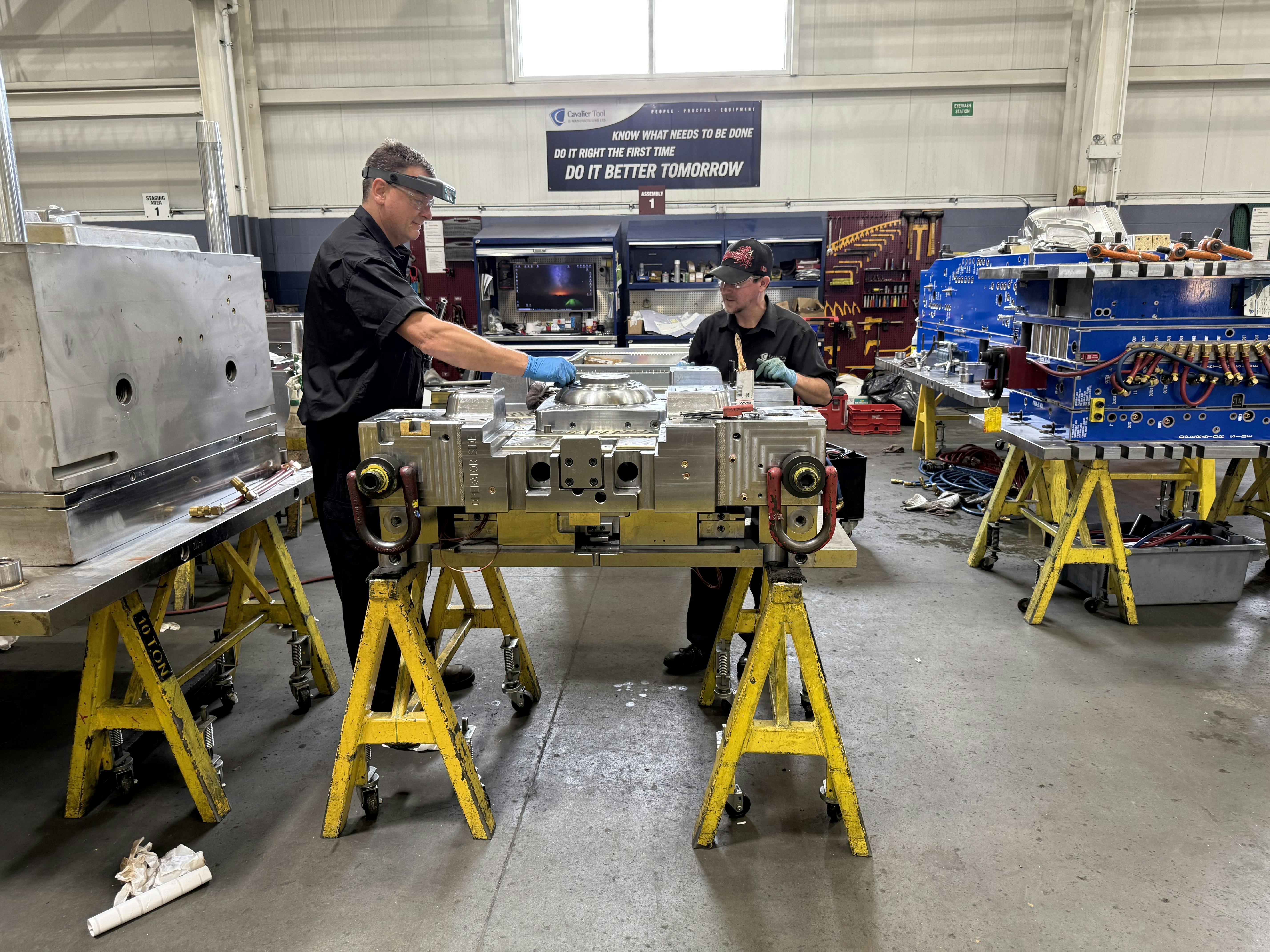 Mold builders assembling a mold.