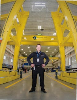 Brian Bendig with some of the 20 cranes at Cavalier Tool.. Brian Bendig with some of the 20 cranes at Cavalier Tool..