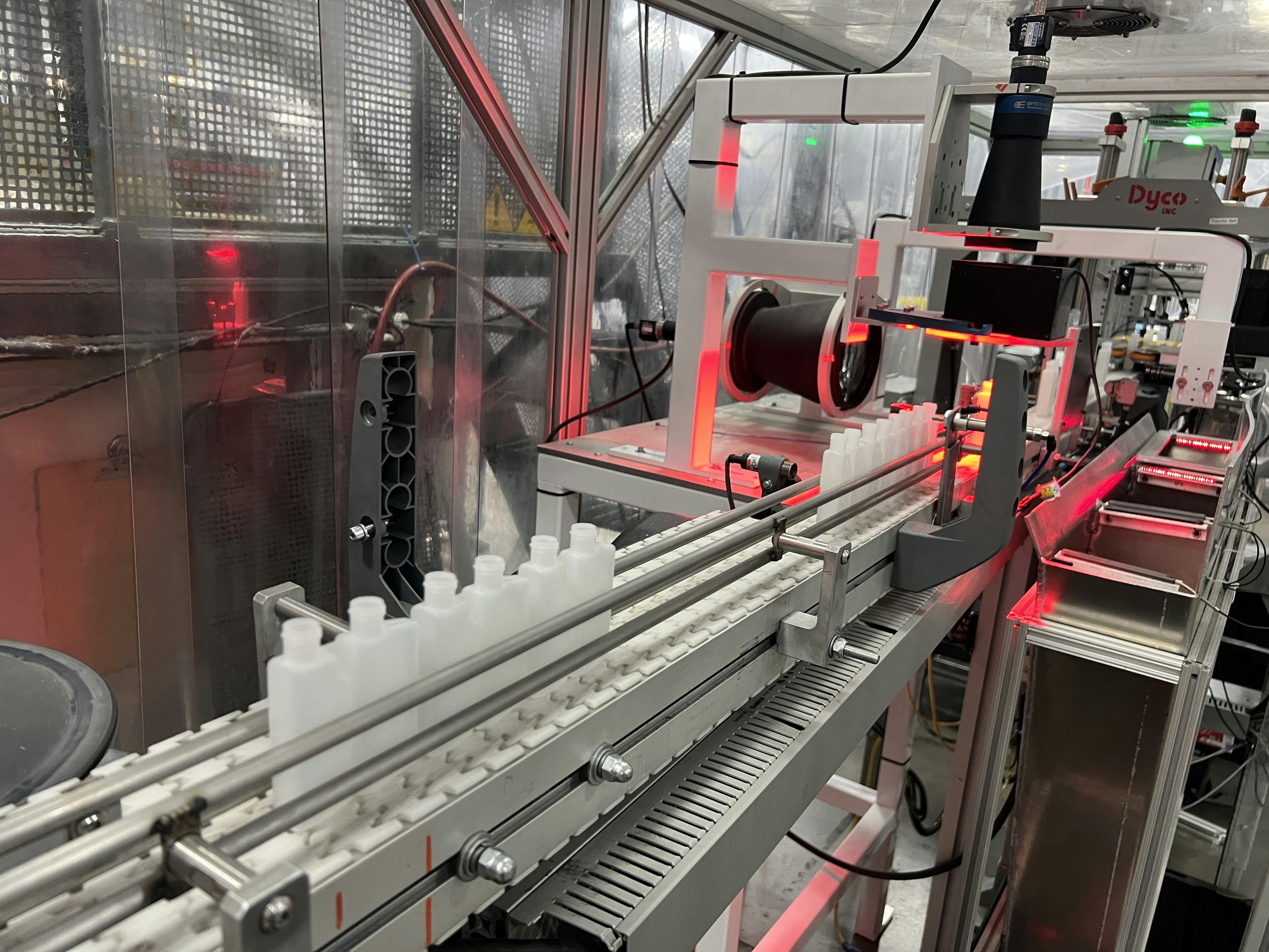 Dual-chamber bottles undergo visual inspection at Currier Plastics