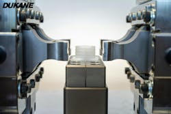 Two welding systems act in unison in the setup to attach a spout to a new package. Two welding systems act in unison in the setup to attach a spout to a new package.