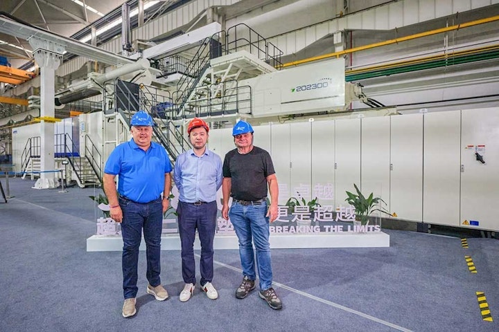 Workers pose with the JU88000 V, an 8,800-ton injection molding machine Haitian delivered to French molder Belli SAS.