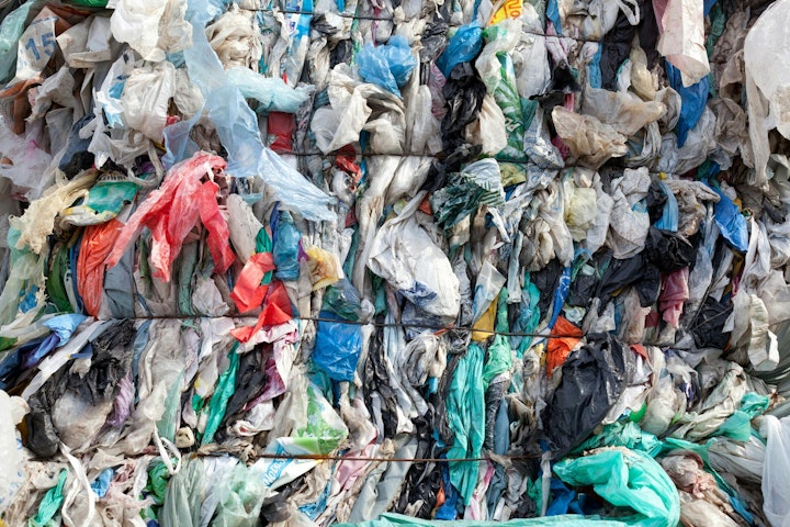 A bale of plastic film for recycling. Advanced recycling has the potential to process heavily contaminated or otherwise difficult materials, such as multilayer packaging.
