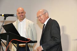 Harald Feuerherm (right) steps to the microphone to accept the Lifetime Achievement Award after an introduction by his grandson, Max. Harald Feuerherm (right) steps to the microphone to accept the Lifetime Achievement Award after an introduction by his grandson, Max.