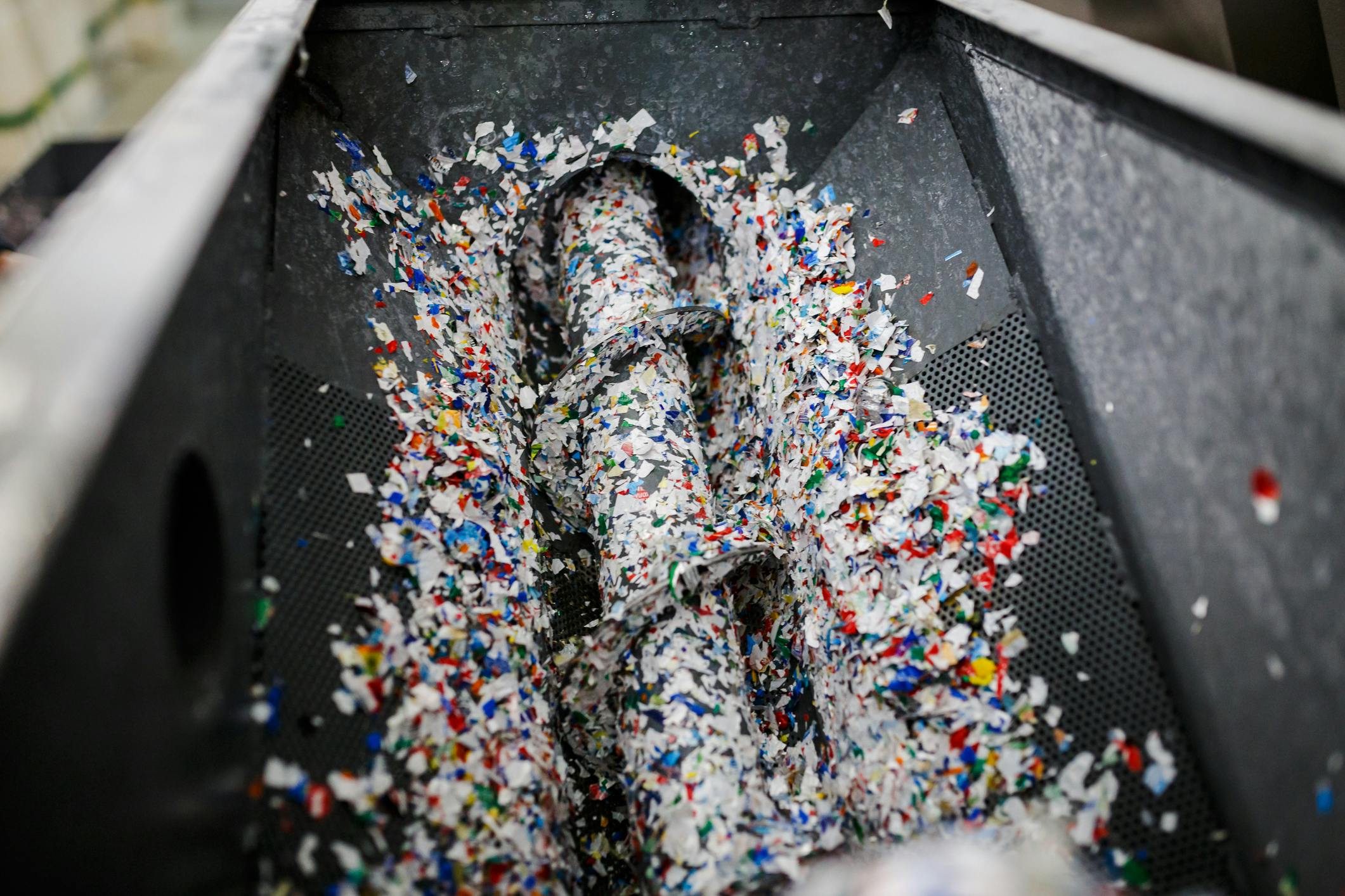 Colorful plastic flakes in a recycling facility.