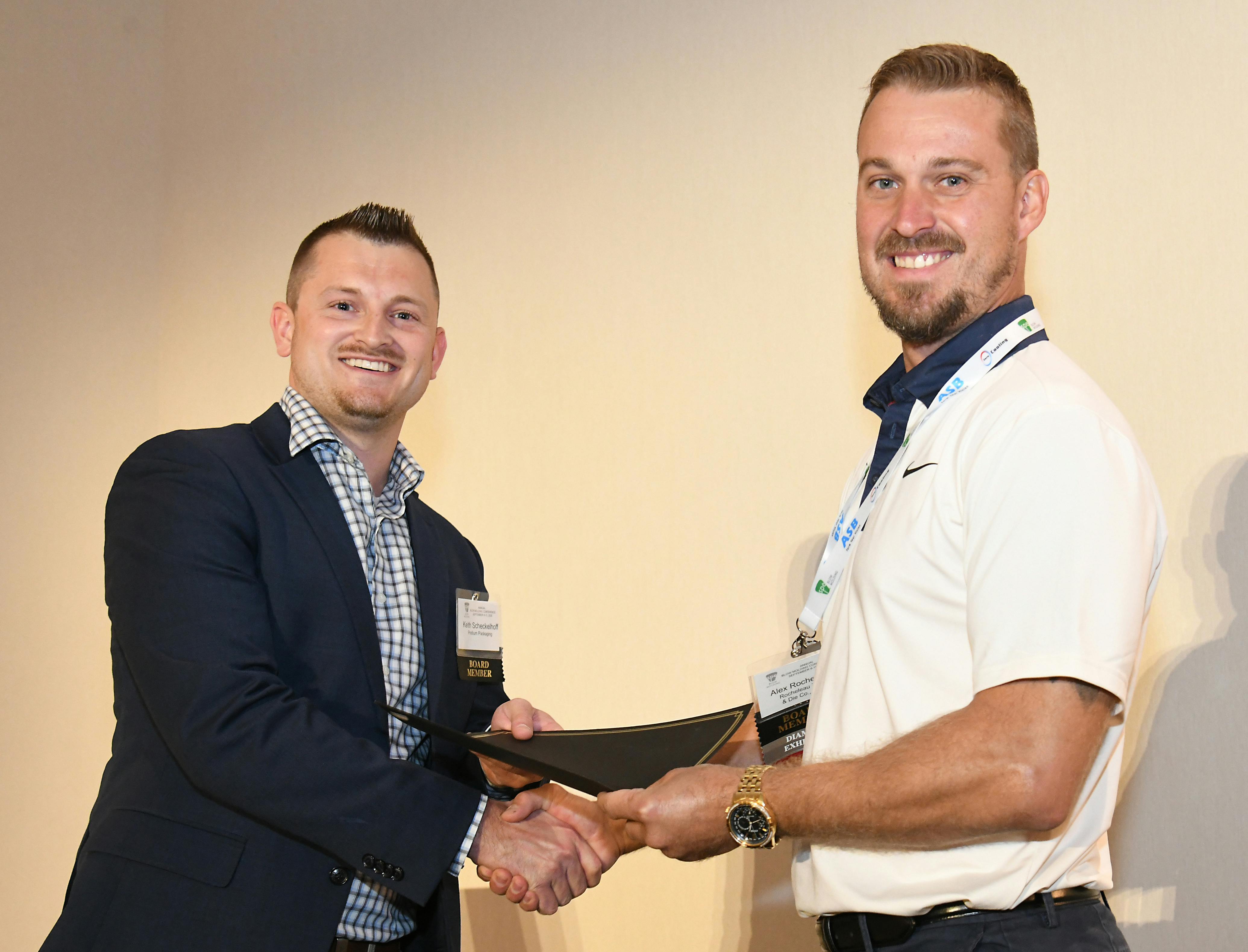 SPE Blow Molding Division board member Keith Scheckelhoff (left) presents the award for the Lew Ferguson Parts Competition to Alex Rocheleau of Rocheleau Tool & Die.