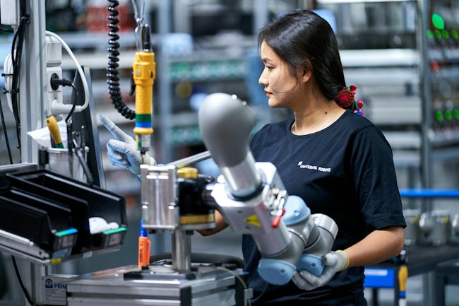 A female worker on Universal Robots' production line at the company's global HQ in Odense, Denmark.