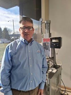 Glenn Frohring, one of the three owners of Absolute Haitian Corp., stands with a vintage press at the company's Parma, Ohio, facility. The press was made by Newbury Industries--a company Frohring's father owned. Glenn Frohring, one of the three owners of Absolute Haitian Corp., stands with a vintage press at the company's Parma, Ohio, facility. The press was made by Newbury Industries--a company Frohring's father owned.