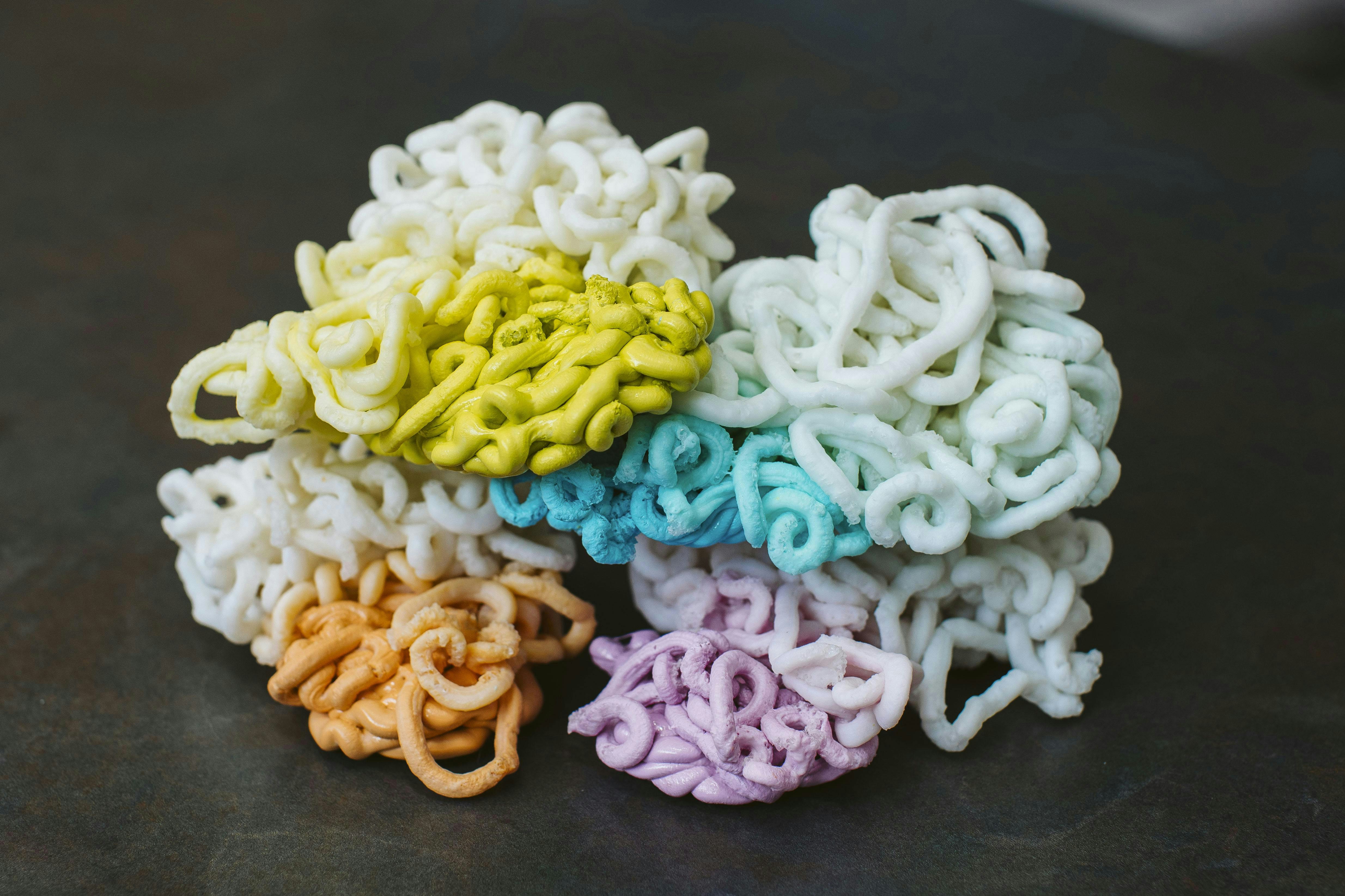 Shuman Plastics used E4 to purge an injection molding machine of colored plastics, producing these piles of plastics, chronicling the process from the beginning, starting with a colorant and ending when that colorant was completely drained from the system.