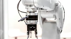 A white industrial robot arm with a gripper end-of-arm tool