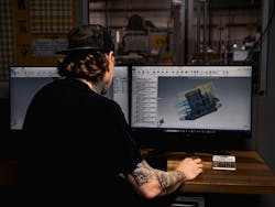 A man works on Mastercam software at a desktop computer A man works on Mastercam software at a desktop computer