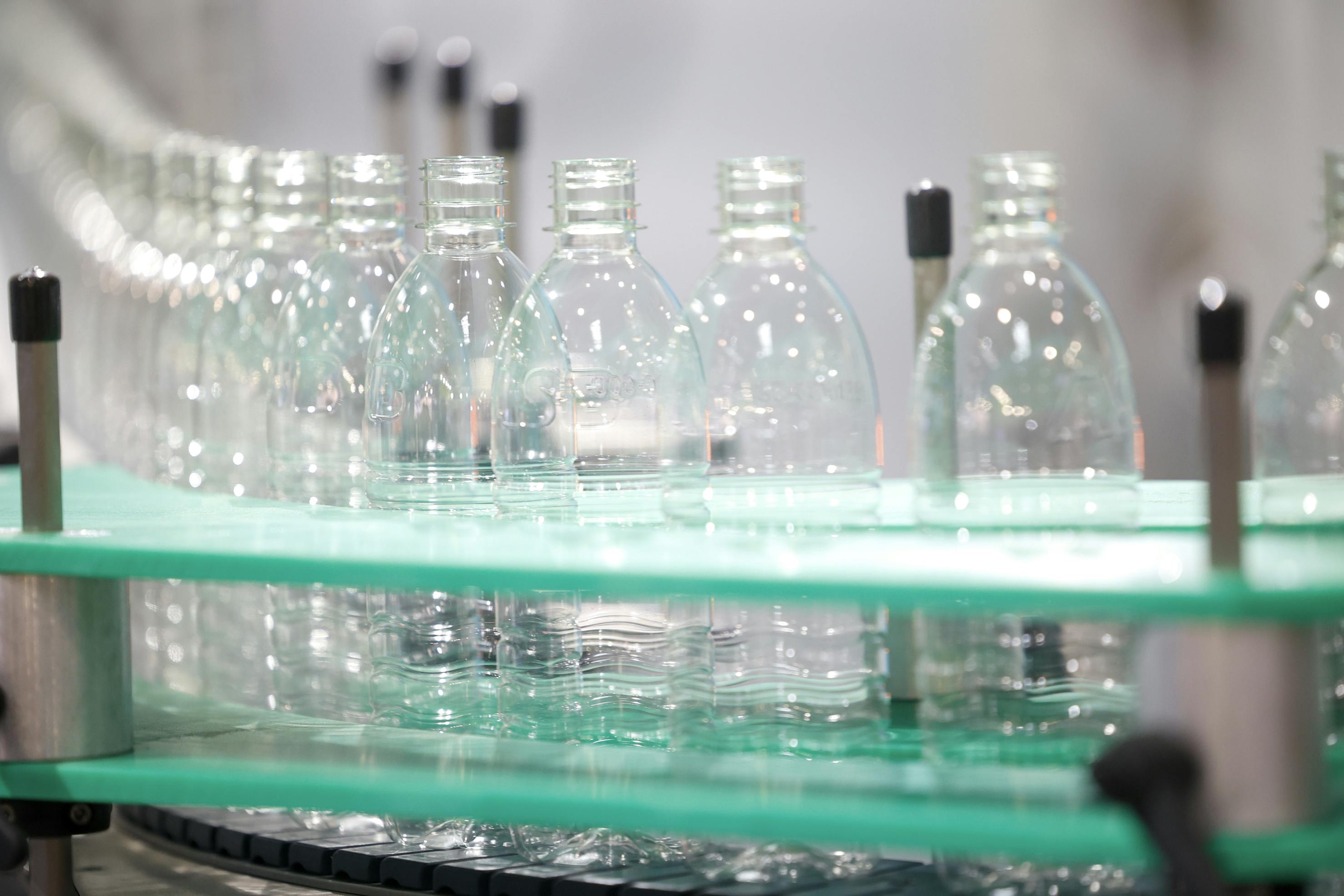 Blow molded bottles on a demonstration line at K 2025.