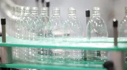 Blow molded bottles on a demonstration line at K 2025.