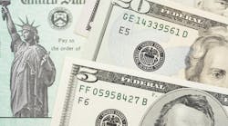 U.S. Treasury check with $5 and $20 bills overlaid U.S. Treasury check with $5 and $20 bills overlaid