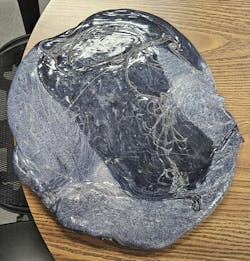 This slab of plastic, produced when a technician tried to clean out an injection molding machine at Tech-Way by simply letting the machine run, shows how much material and time are wasted when purging compound isn't used as part of a material or color changeover. This slab of plastic, produced when a technician tried to clean out an injection molding machine at Tech-Way by simply letting the machine run, shows how much material and time are wasted when purging compound isn't used as part of a material or color changeover.
