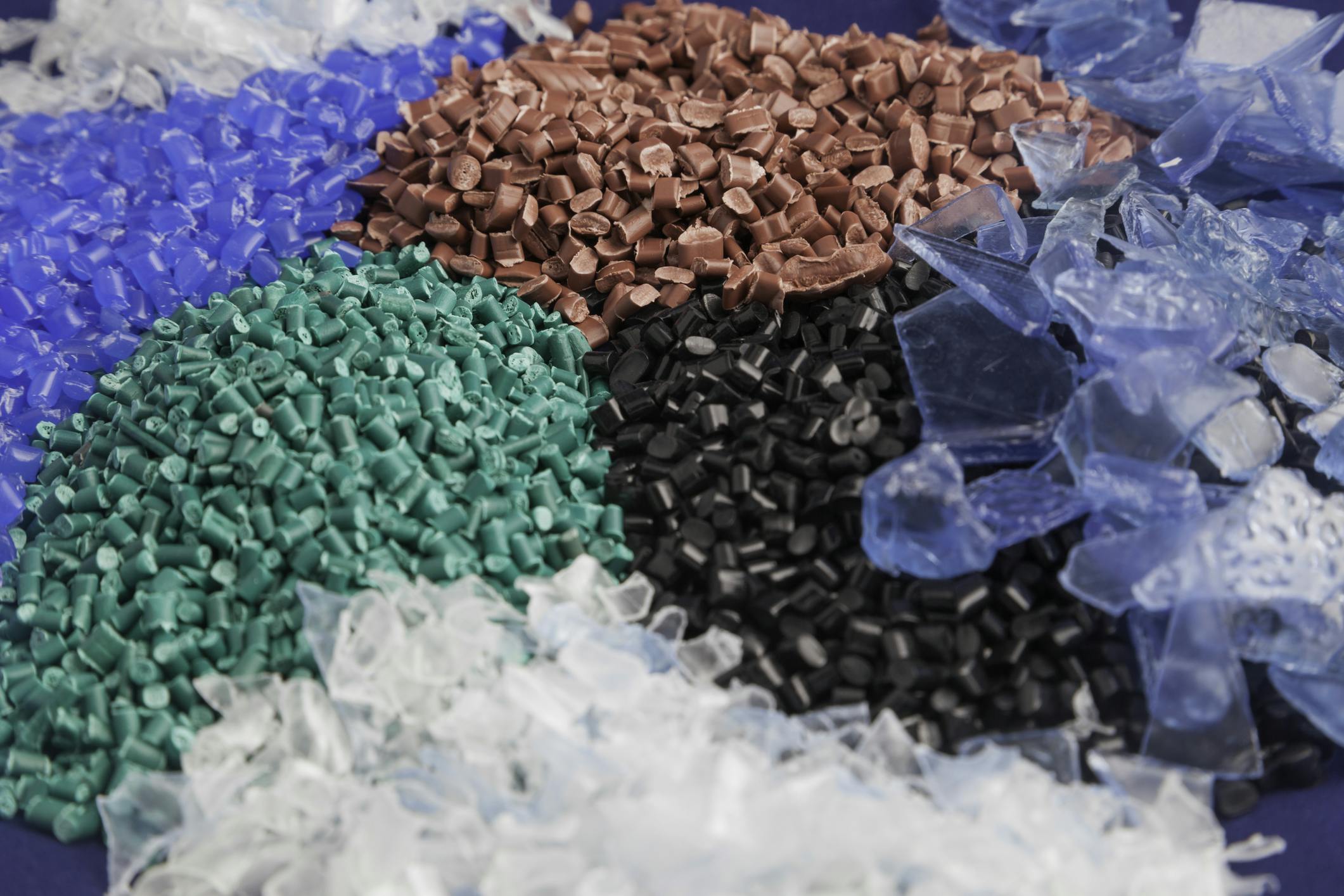 Recycled plastic pellets in various colors.