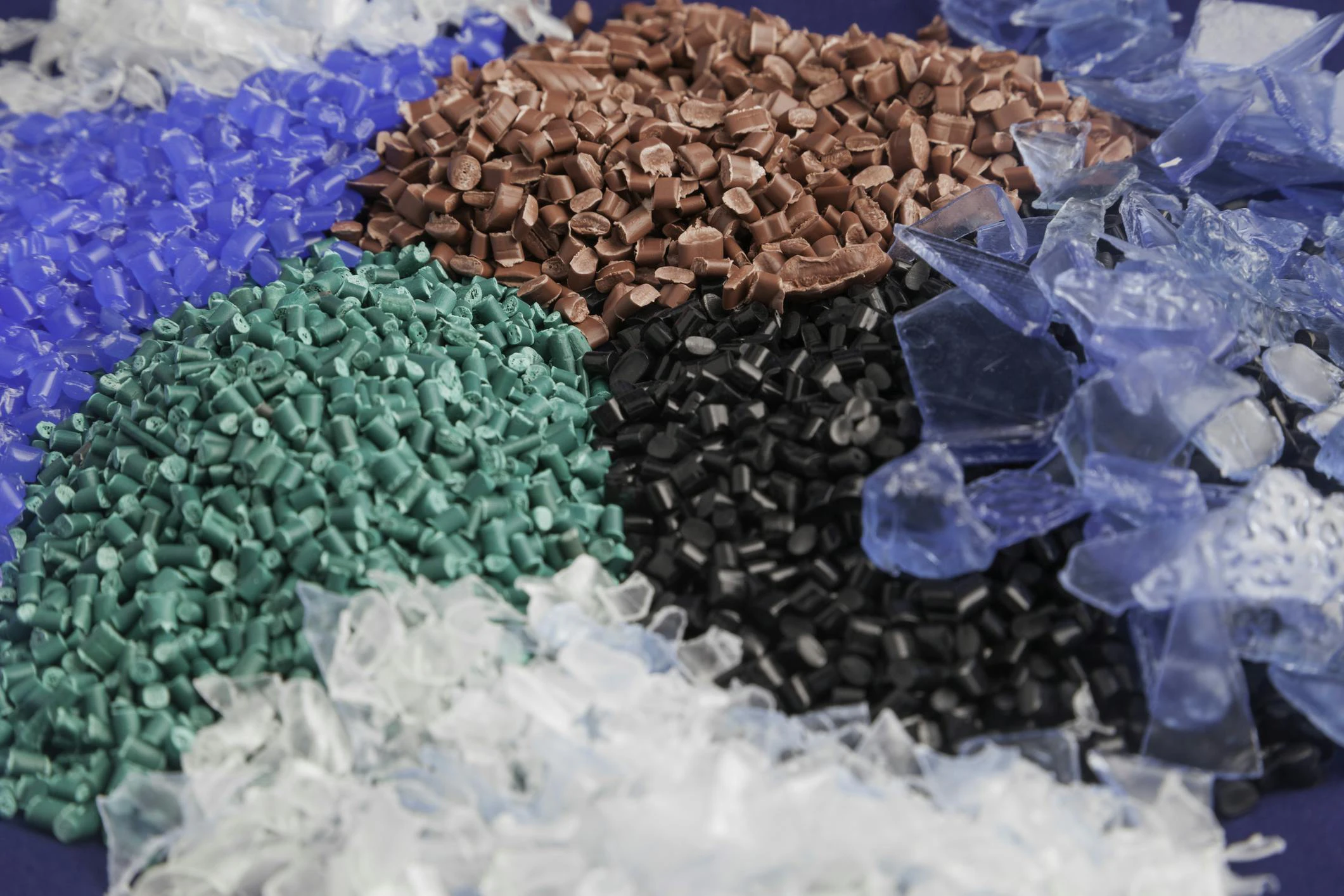 Recycled plastic pellets in various colors.