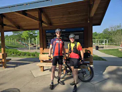 Brett Greenhalgh describes bicycling as his 'happy place.' He's done many 100-mile-or-more rides, including a ride a few summers ago from his home in the Cincinnati area to Cleveland spanning more than 200 miles. Here, he takes a break with his cousin, Trace Lund, during a 2024 bicycle ride on the Katy Trail from Kansas City, Mo., to St. Louis. Brett Greenhalgh describes bicycling as his 'happy place.' He's done many 100-mile-or-more rides, including a ride a few summers ago from his home in the Cincinnati area to Cleveland spanning more than 200 miles. Here, he takes a break with his cousin, Trace Lund, during a 2024 bicycle ride on the Katy Trail from Kansas City, Mo., to St. Louis.