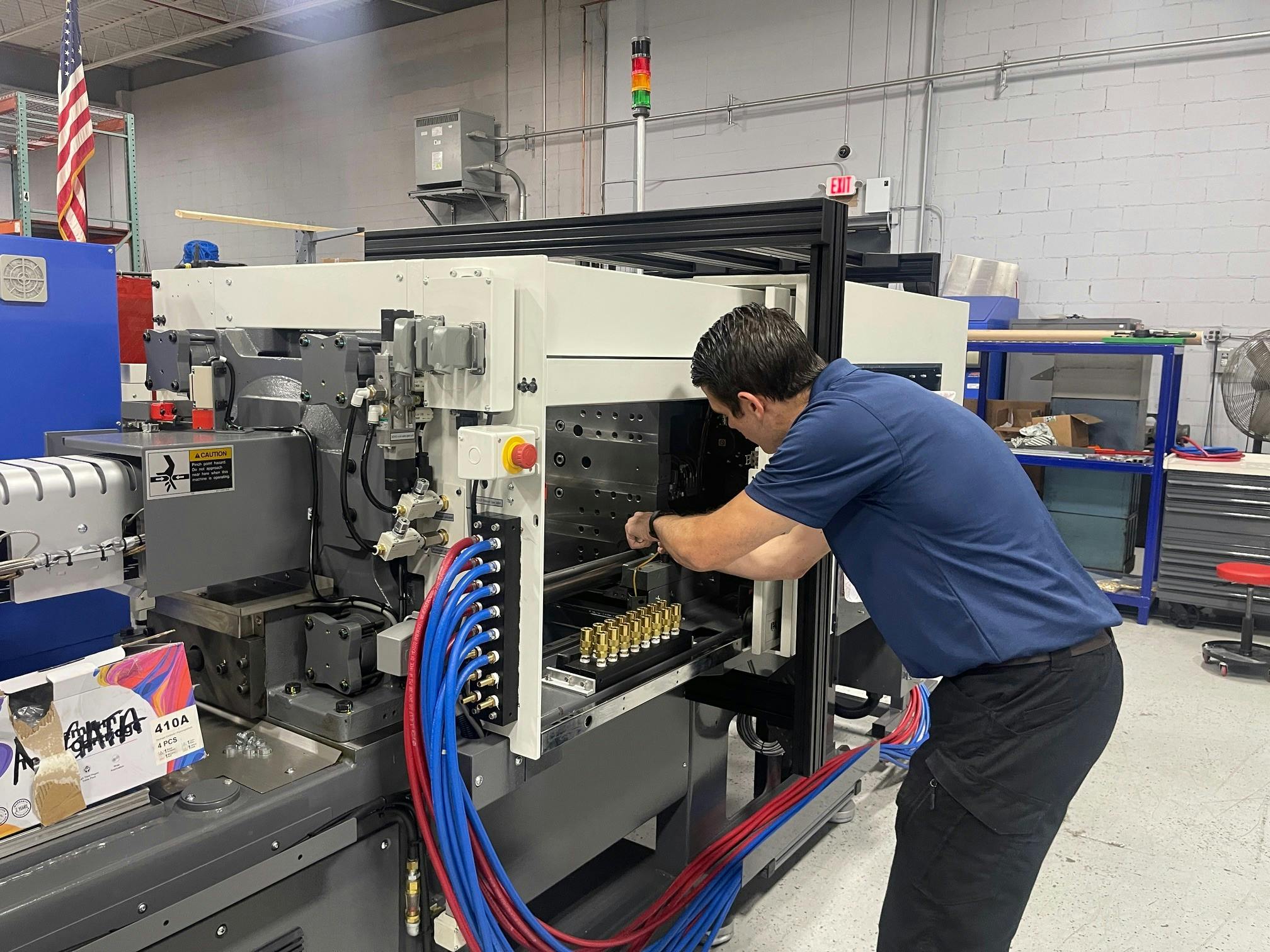 An Absolute Haitian technician works on a press. According to representatives of some OEMs, maintenance is taking on new urgency, as manufacturers look to extend the service life of their machines.
