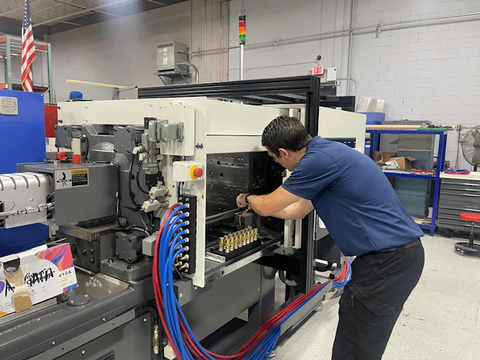 An Absolute Haitian technician works on a press. According to representatives of some OEMs, maintenance is taking on new urgency, as manufacturers look to extend the service life of their machines.