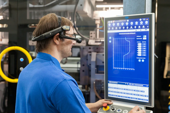 A Bekum technician uses Industry 4.0 tools to look over a machine. Increasingly, Christian Richard, corporate communications manager and sales administration manager for the OEM, said, &ldquo;Maintenance in extrusion blow molding is no longer reactive &mdash; it is strategic.'