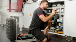A technician crouches beside Wittmann equipment. Like other OEMs, Wittmann is working to make its machines easier to use, with tools that will help processors better spot trends that could indicate future maintenance needs. A technician crouches beside Wittmann equipment. Like other OEMs, Wittmann is working to make its machines easier to use, with tools that will help processors better spot trends that could indicate future maintenance needs.
