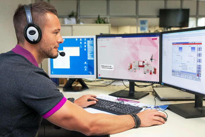 A Wittmann technician looks over data about machine health. New artificial intelligence (AI)-powered tools put control at the tip of operators' fingerprints, reducing the possibility of unplanned downtime.