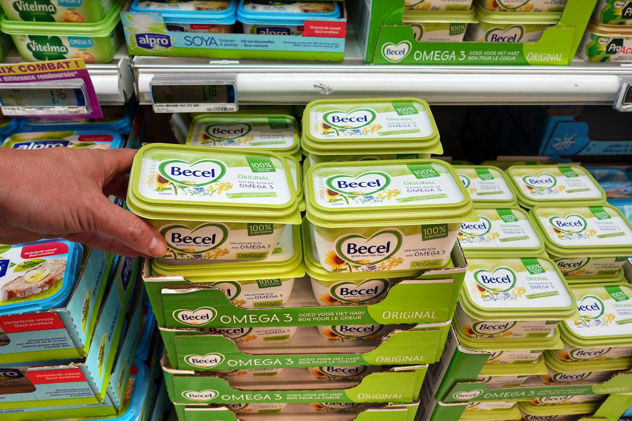 Plastic margarine tubs on display at a grocery store.