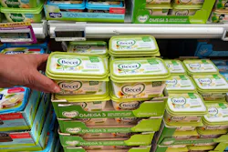 Plastic margarine tubs on display at a grocery store. Plastic margarine tubs on display at a grocery store.
