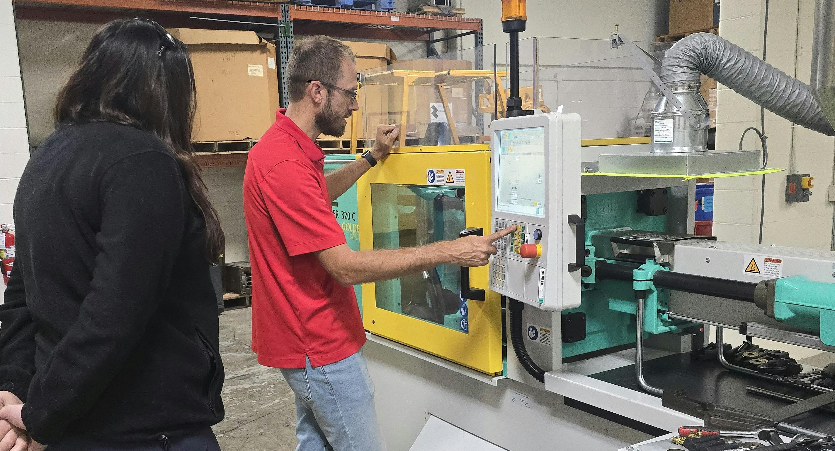 Tom Van Pernis of Ferris State University&rsquo;s plastics engineering technology program at an injection molding machine.