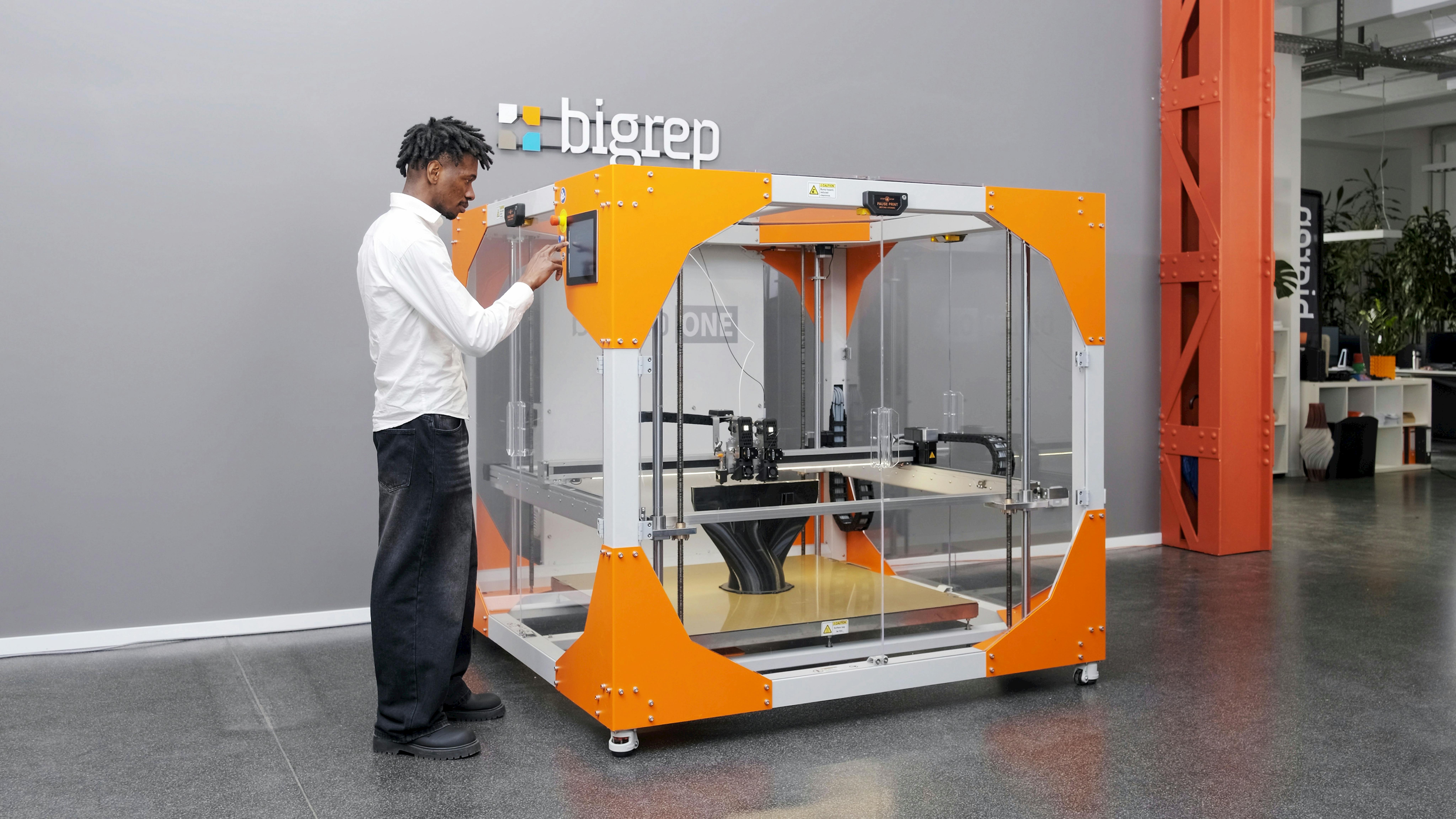A man operates the BigRep One.5X 3D printer