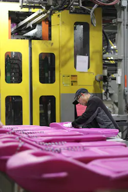 Hoa Bui trims a sled at Confer Plastics. Like many workers at the blow molding shop, he's an immigrant, hailing from Vietnam. Hoa Bui trims a sled at Confer Plastics. Like many workers at the blow molding shop, he's an immigrant, hailing from Vietnam.