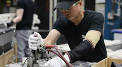 Tien Nguyen, from Vietnam, works on a swimming-pool ladder part at Confer Plastics. Tien Nguyen, from Vietnam, works on a swimming-pool ladder part at Confer Plastics.