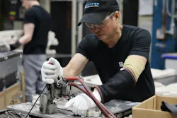 Tien Nguyen, from Vietnam, works on a swimming-pool ladder part at Confer Plastics. Tien Nguyen, from Vietnam, works on a swimming-pool ladder part at Confer Plastics.