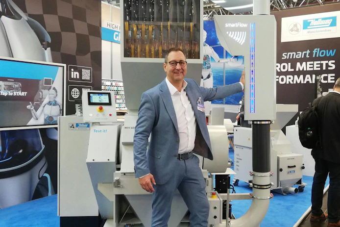 Managing director Mark Hellweg mans his company's stand at K 2025.