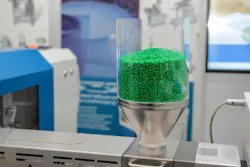 Green plastic pellets ready to be processed into parts. Green plastic pellets ready to be processed into parts.