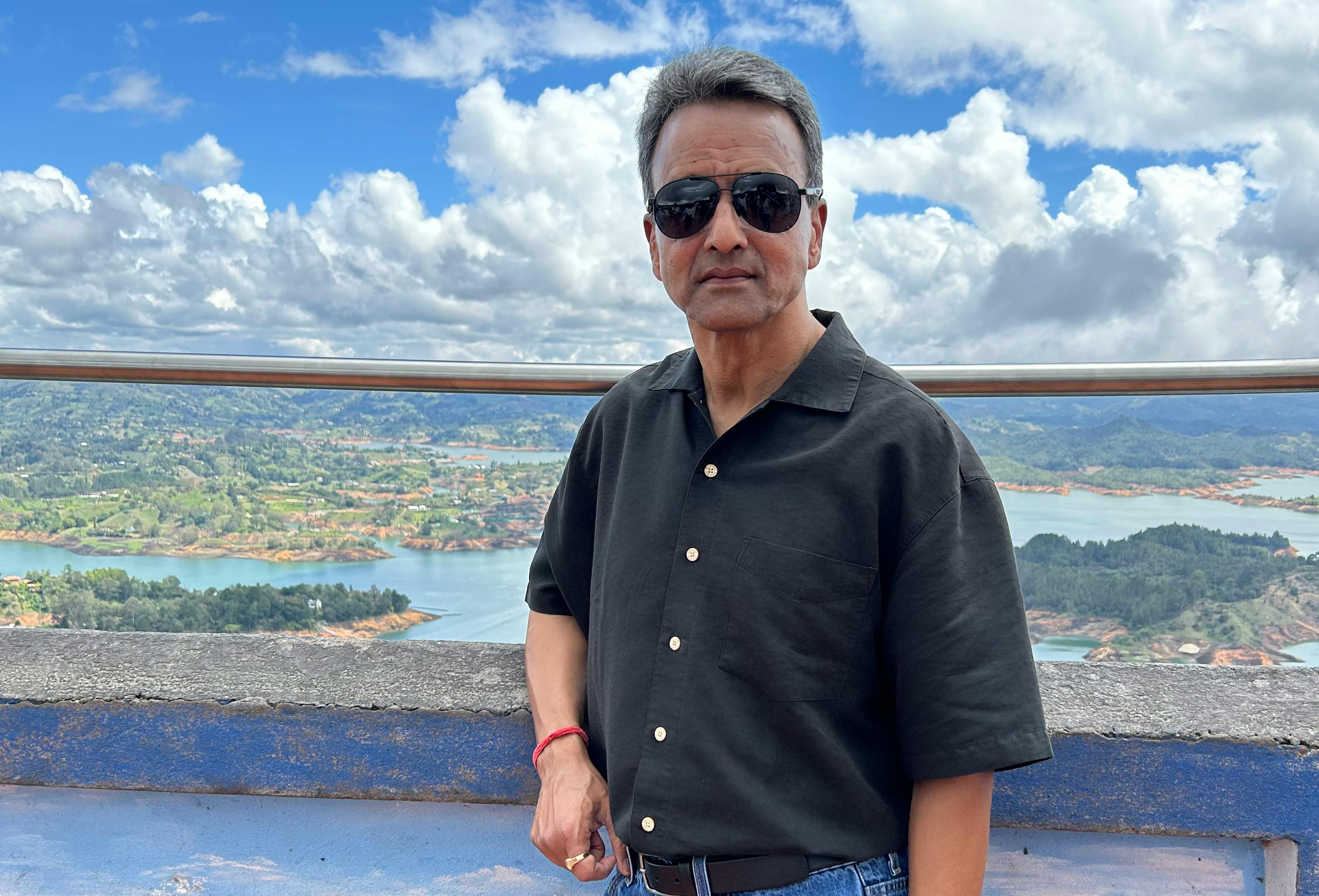 Mahesh Gupta stands atop of Rock of Guatap&eacute; in Columbia.