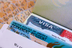 A United States visa and green card. A United States visa and green card.