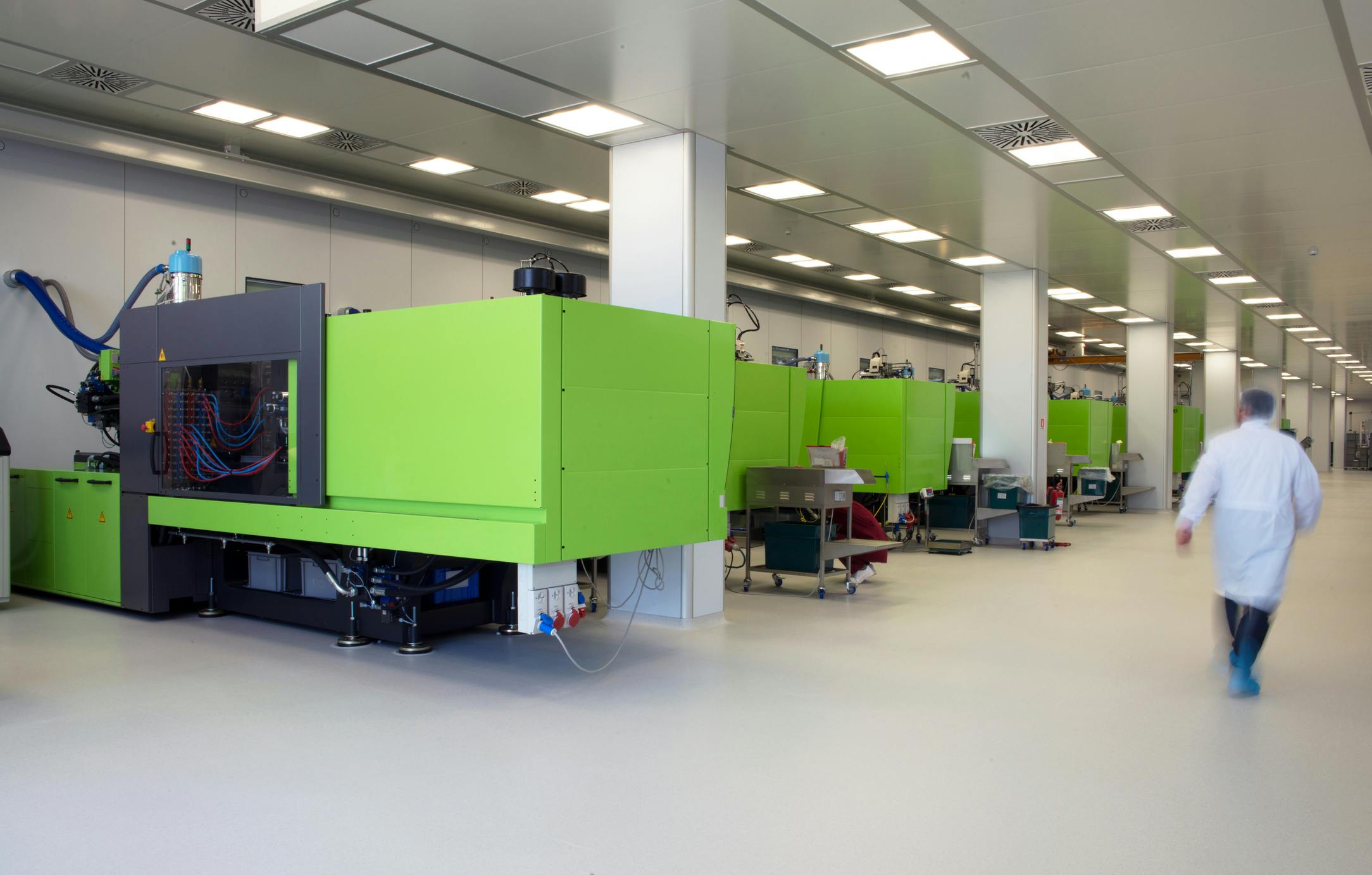 Injection molding machines for medical manufacturing in a clean room.