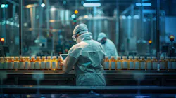 Workers inspect plastic bottles on a production line.