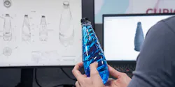 Hands hold a blue bottle in front of a screen showing simulations of the bottle design.