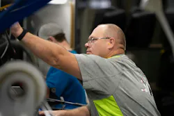 Workers on a blow molding line at Agri-Industrial Plastics