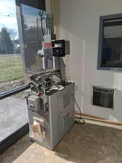 1960s-era injection molding machine in foyer of Absolute Haitian's offices