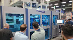 Attendees at Uniloy's July 23 open house watch a UCS 30.ED blow molding machine in operation.