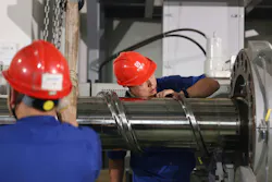Workers assemble a 360mm single-screw extruder at a plant in China.