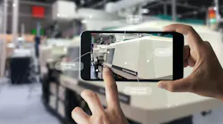 A smartphone shows various parts of an injection molding machine to a user.