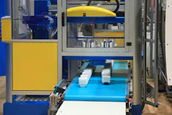 Plastic containers come off an injection molding line.