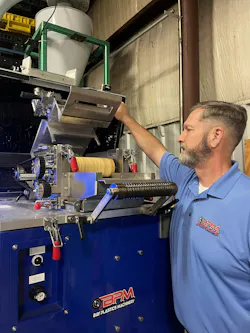 Jason Forgash looks into an AXP08 Strand Pelletizer with the S.M.A.R.T System controller.
