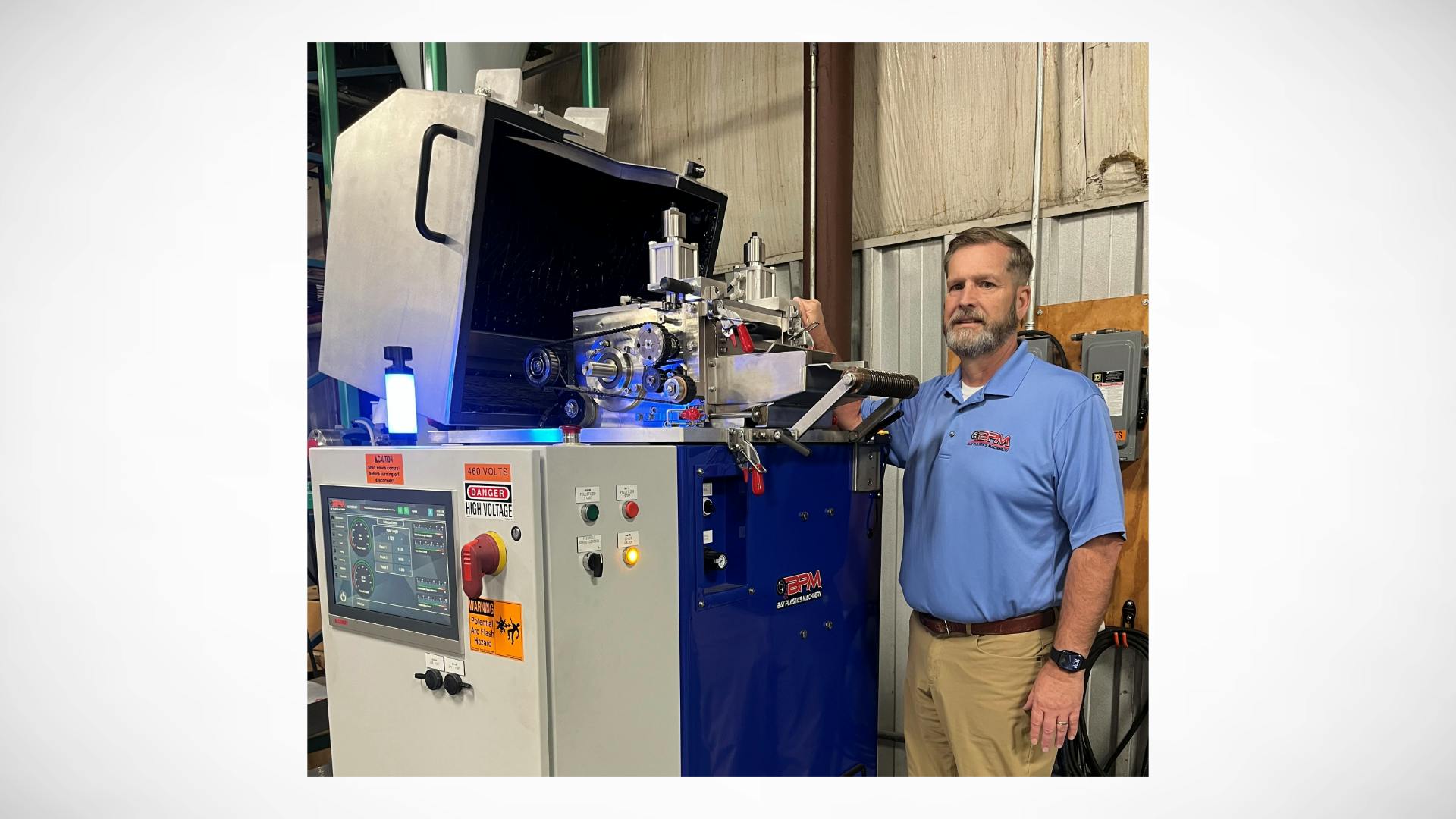 Jason Forgash, CEO of Bay Plastics Machinery, with an AXP08 Strand Pelletizer with the S.M.A.R.T. System controller.